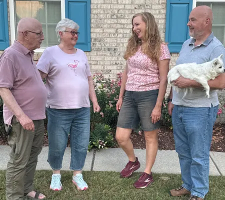 married couple talking with parents and in-laws at home