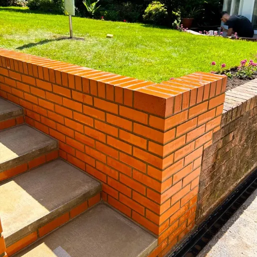 Our Cardiff landscapers built up this brick wall and steps to integrate with the existing garden.png