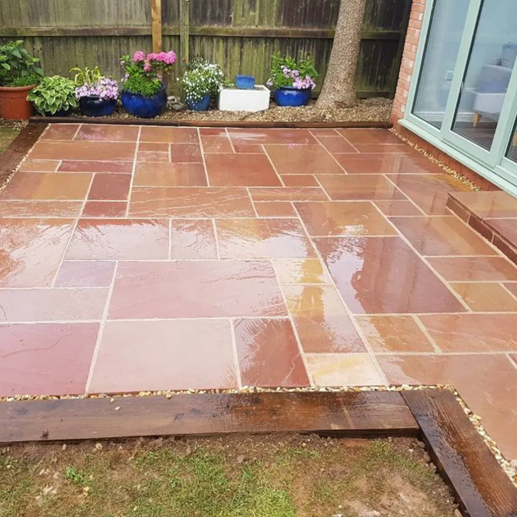 Back garden patio area with a wooden sleeper boarder