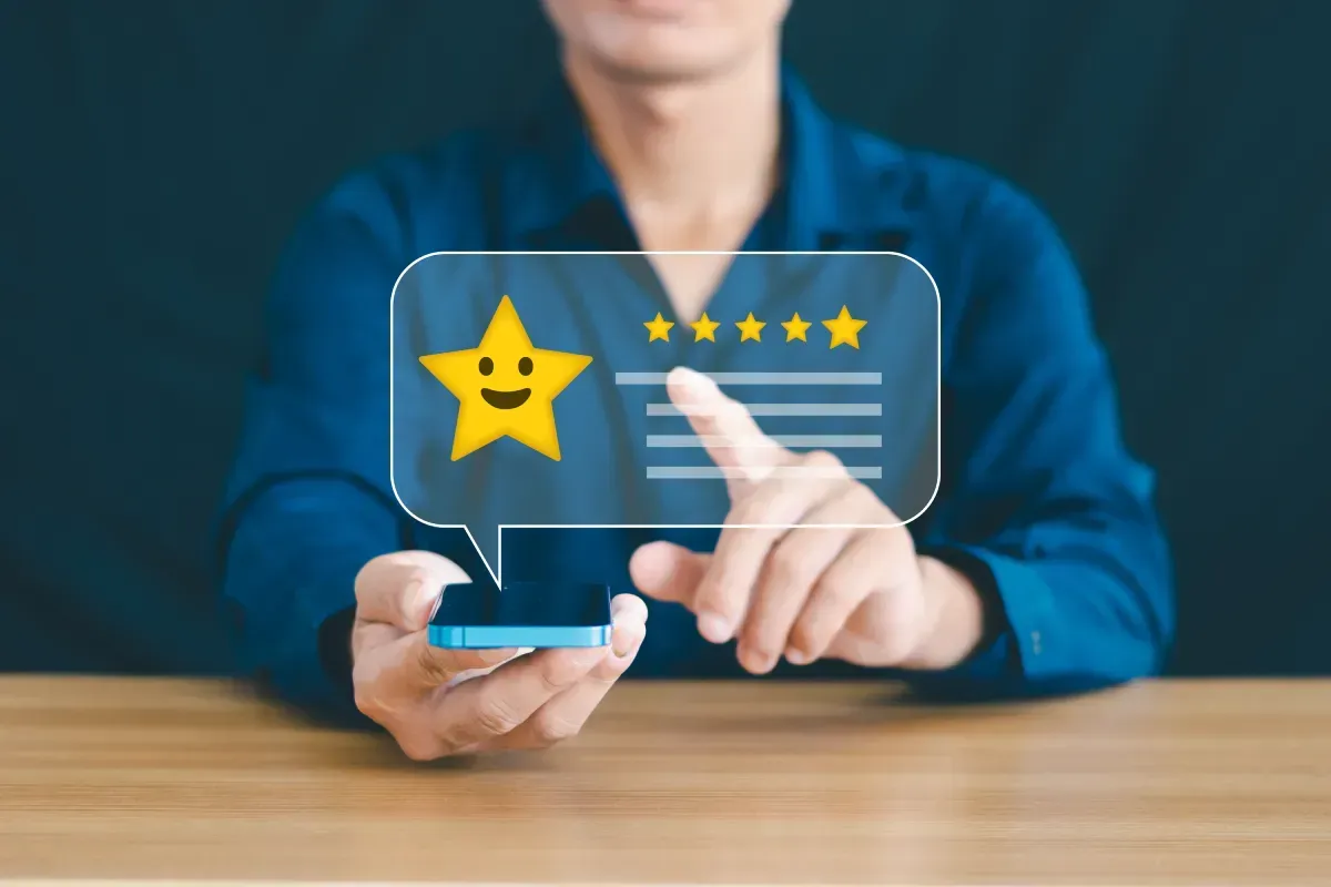 get more 5-star reviews on Google. image of a man holding a phone leaving a 5 star review on Google. 