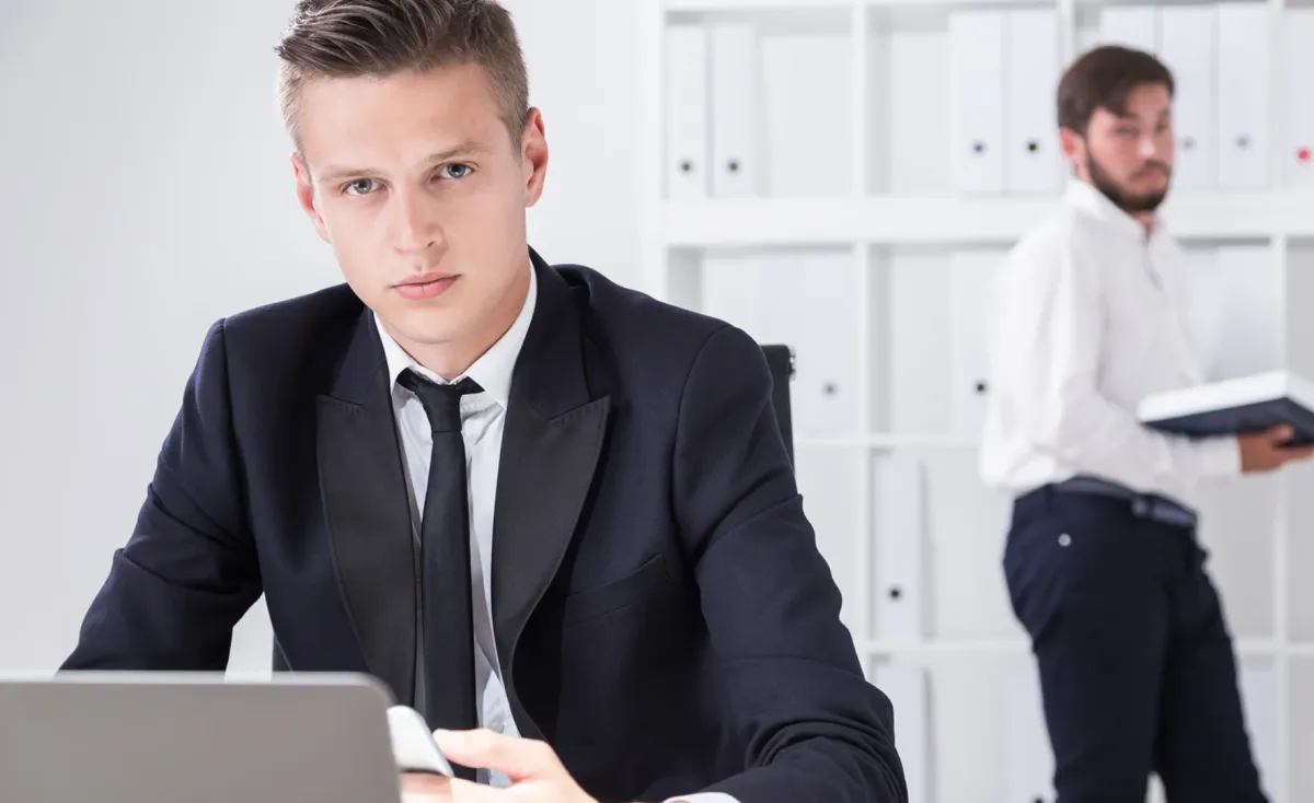 man standing in front of group of men