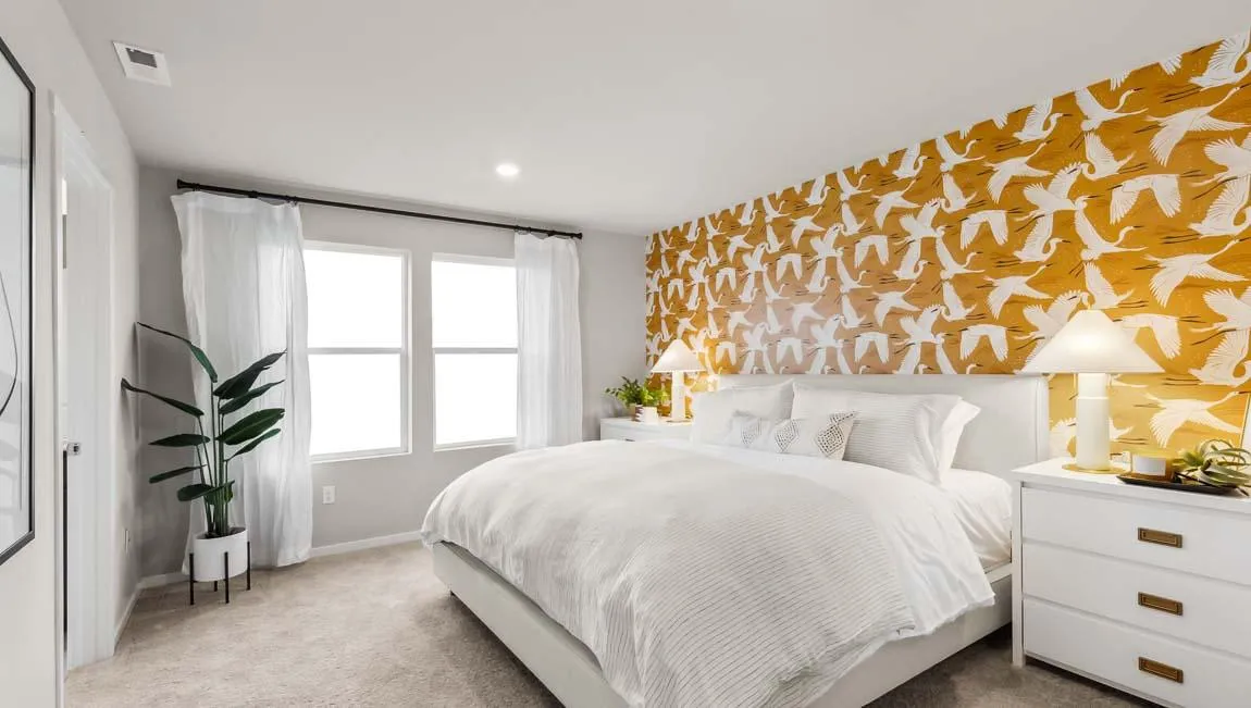 a bedroom with a bed and a large window