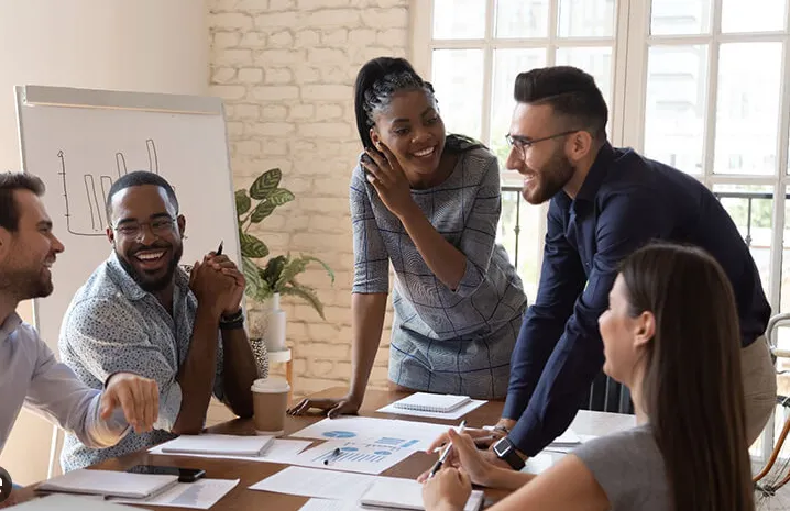 man standing behind flat screen computer monitor