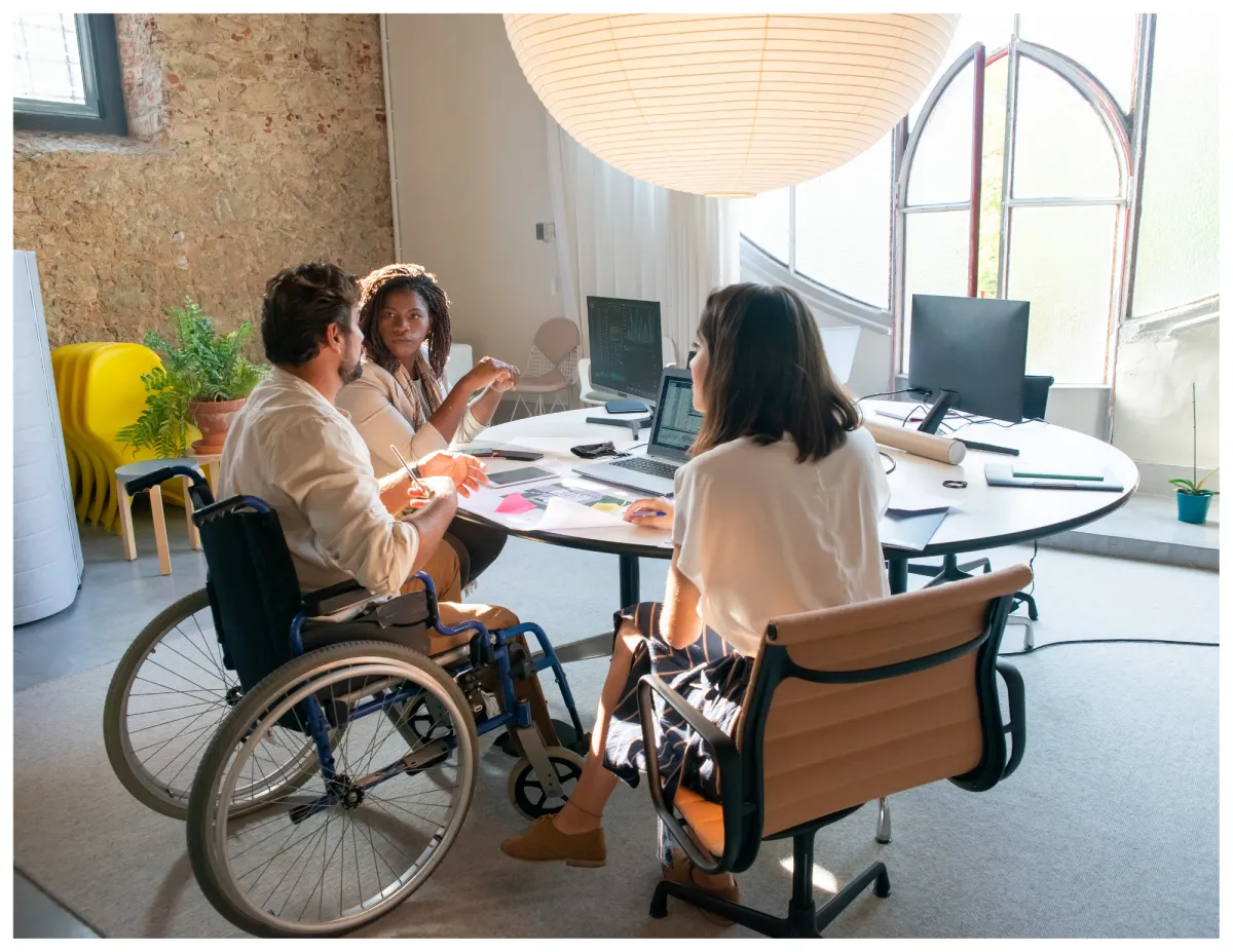 a couple of people sitting at a table with a laptop