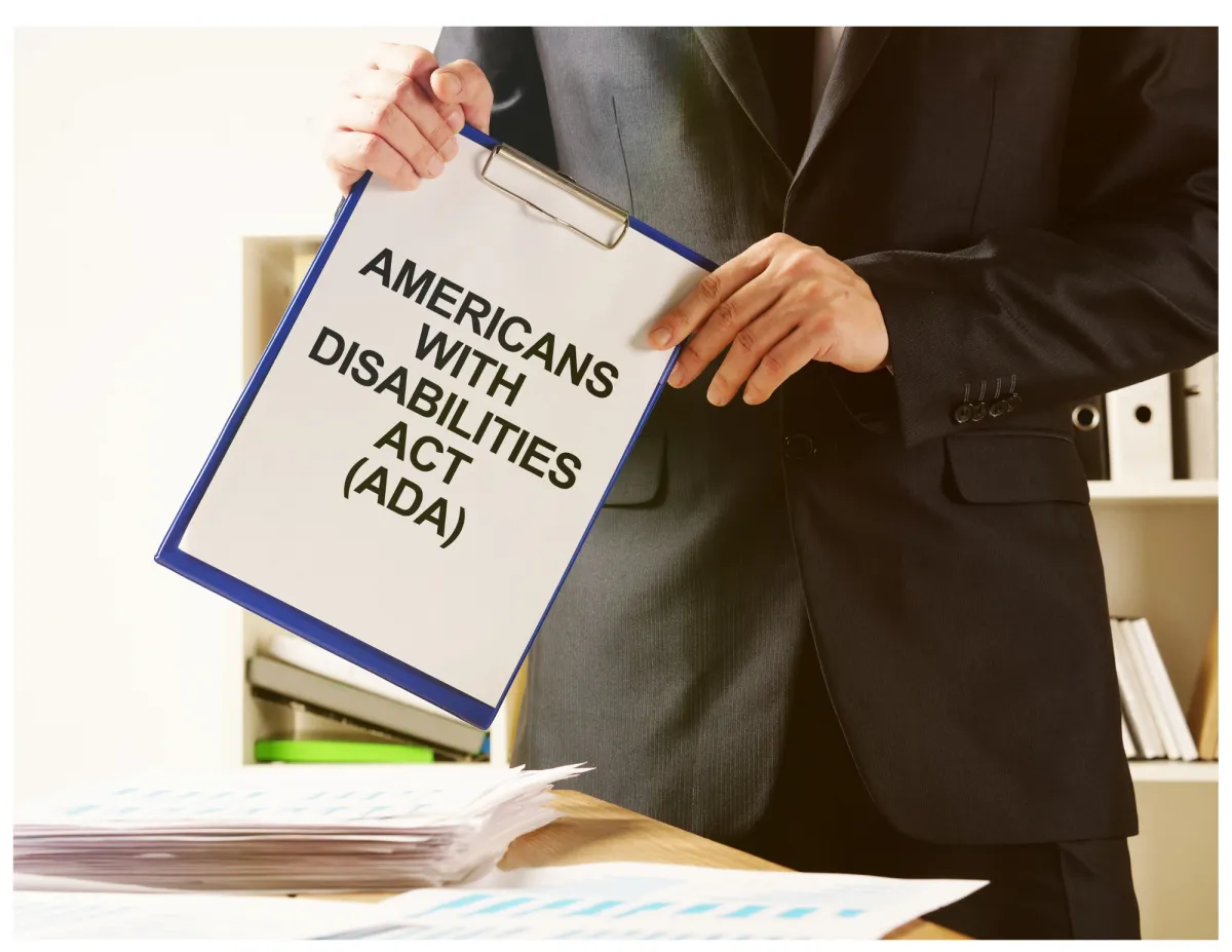 man standing behind flat screen computer monitor