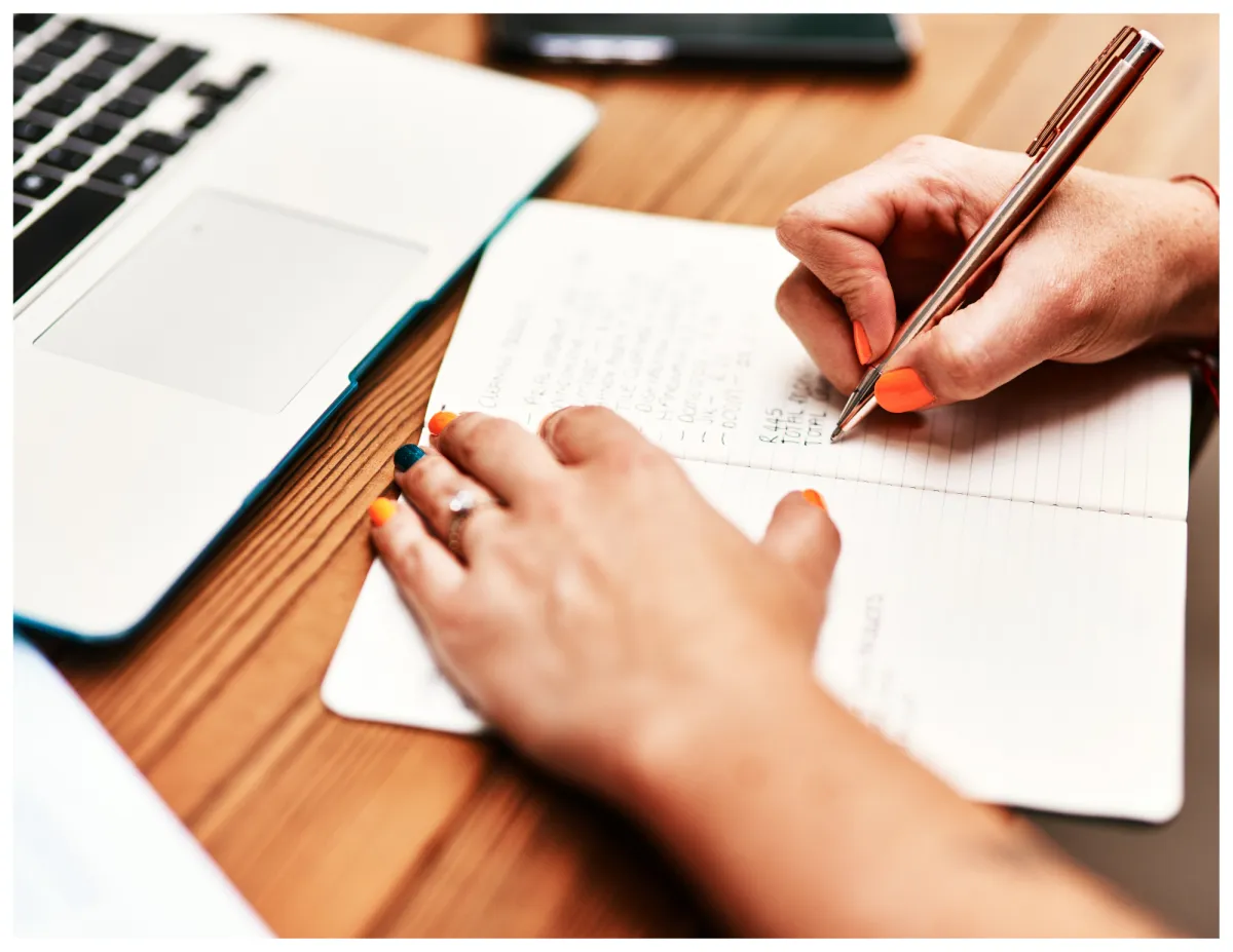 woman placing sticky notes on wall