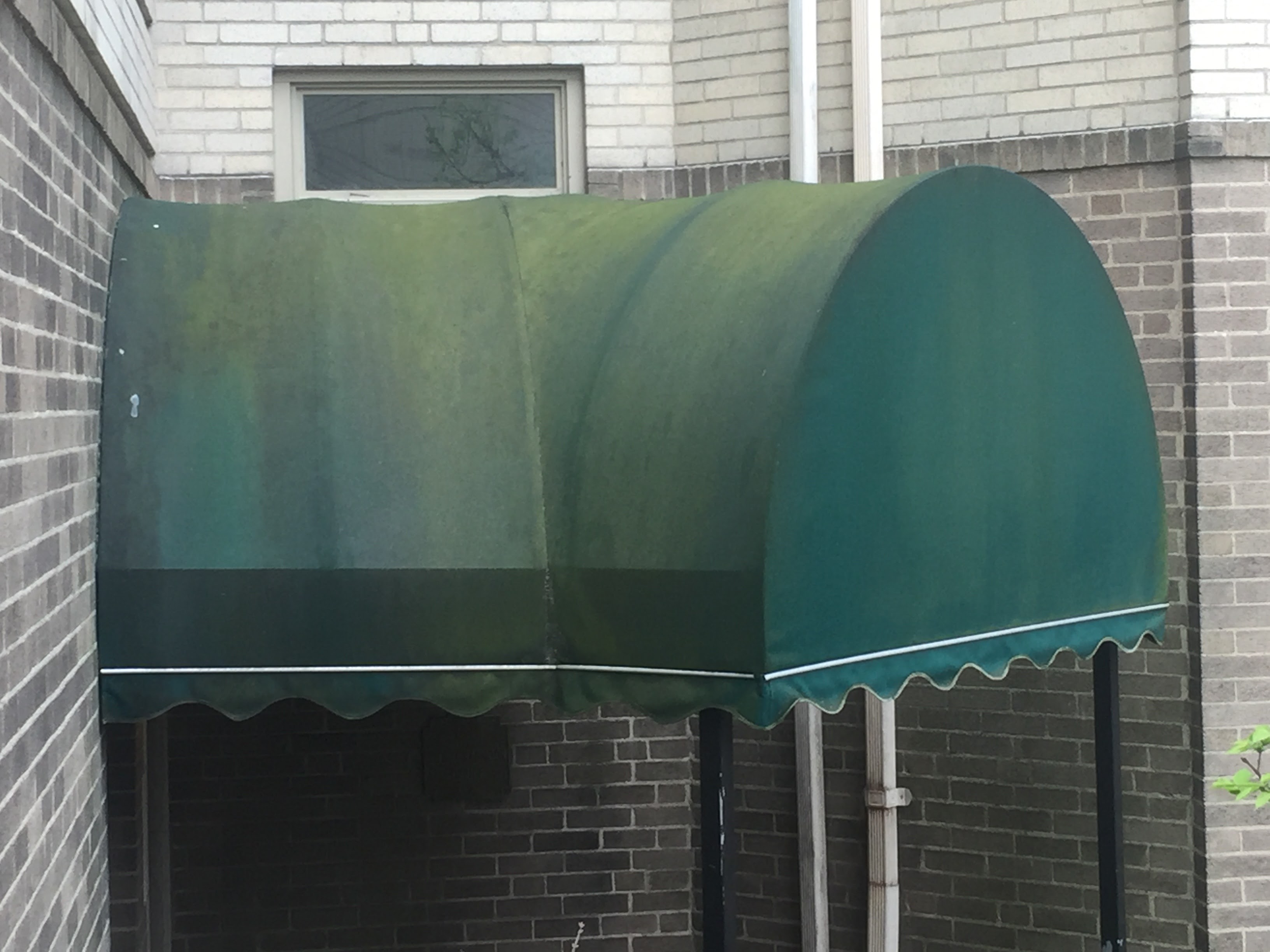 Commercial awning before exterior cleaning – Missions Pressure Washing service example