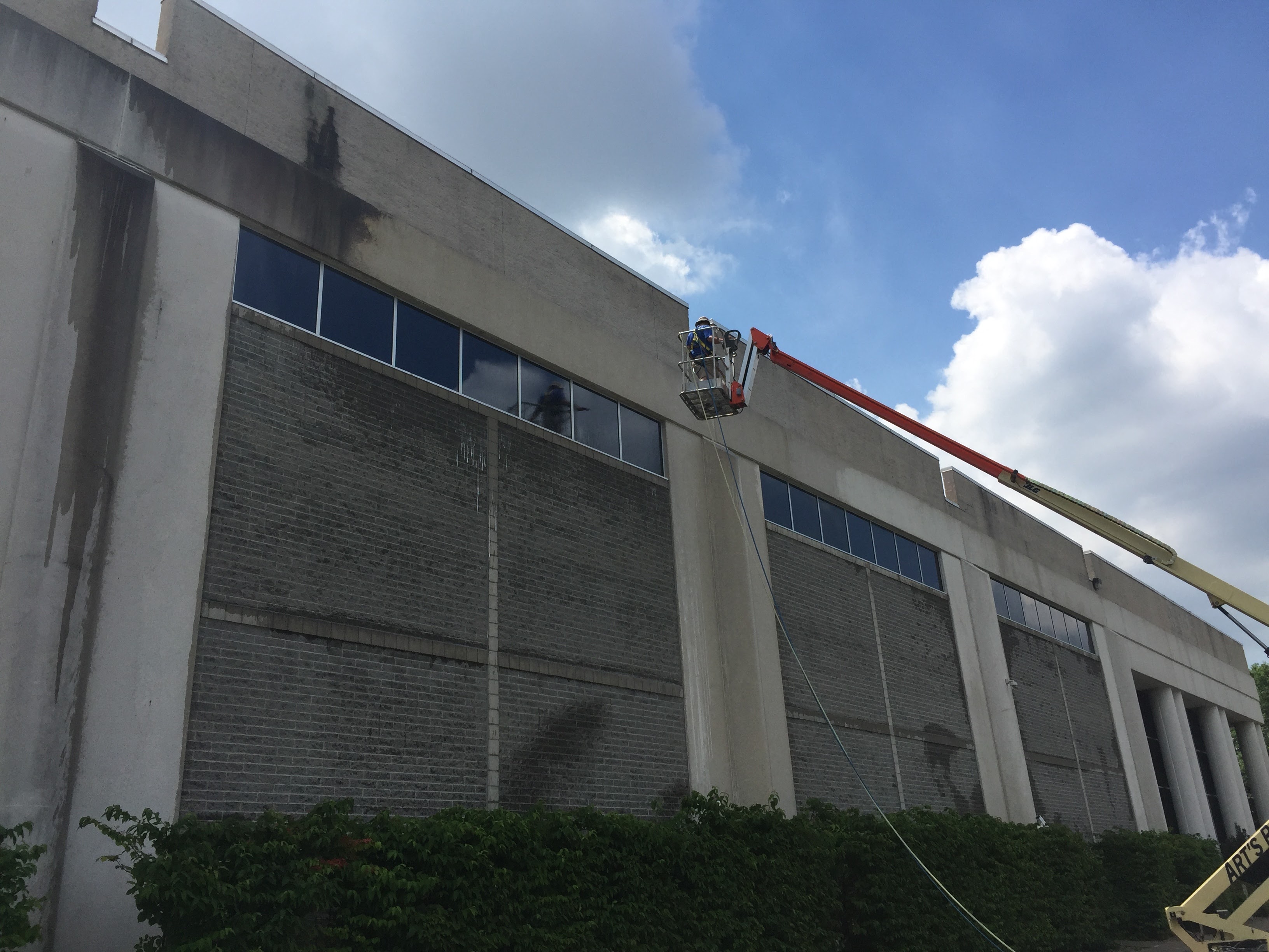Commercial high-reach exterior cleaning with man lift – Missions Pressure Washing service example