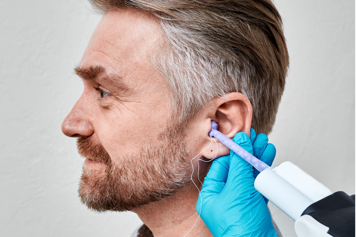 man having custom ear impressions taken