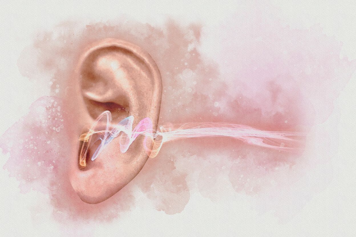 woman holding her ear in pain