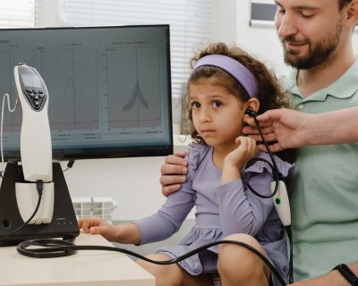 little girl taking a hearing test