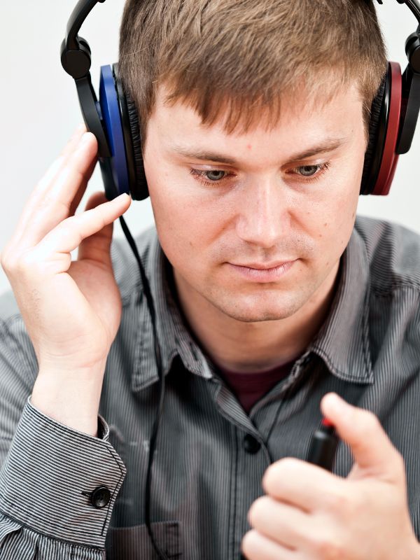 man holding his ear in pain and the ear is glowing red