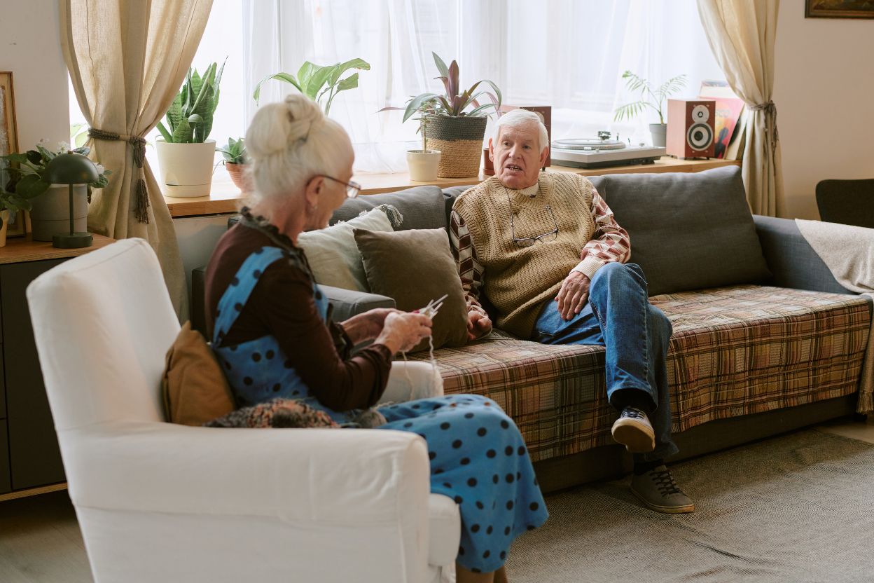 an older couple talking on the couch