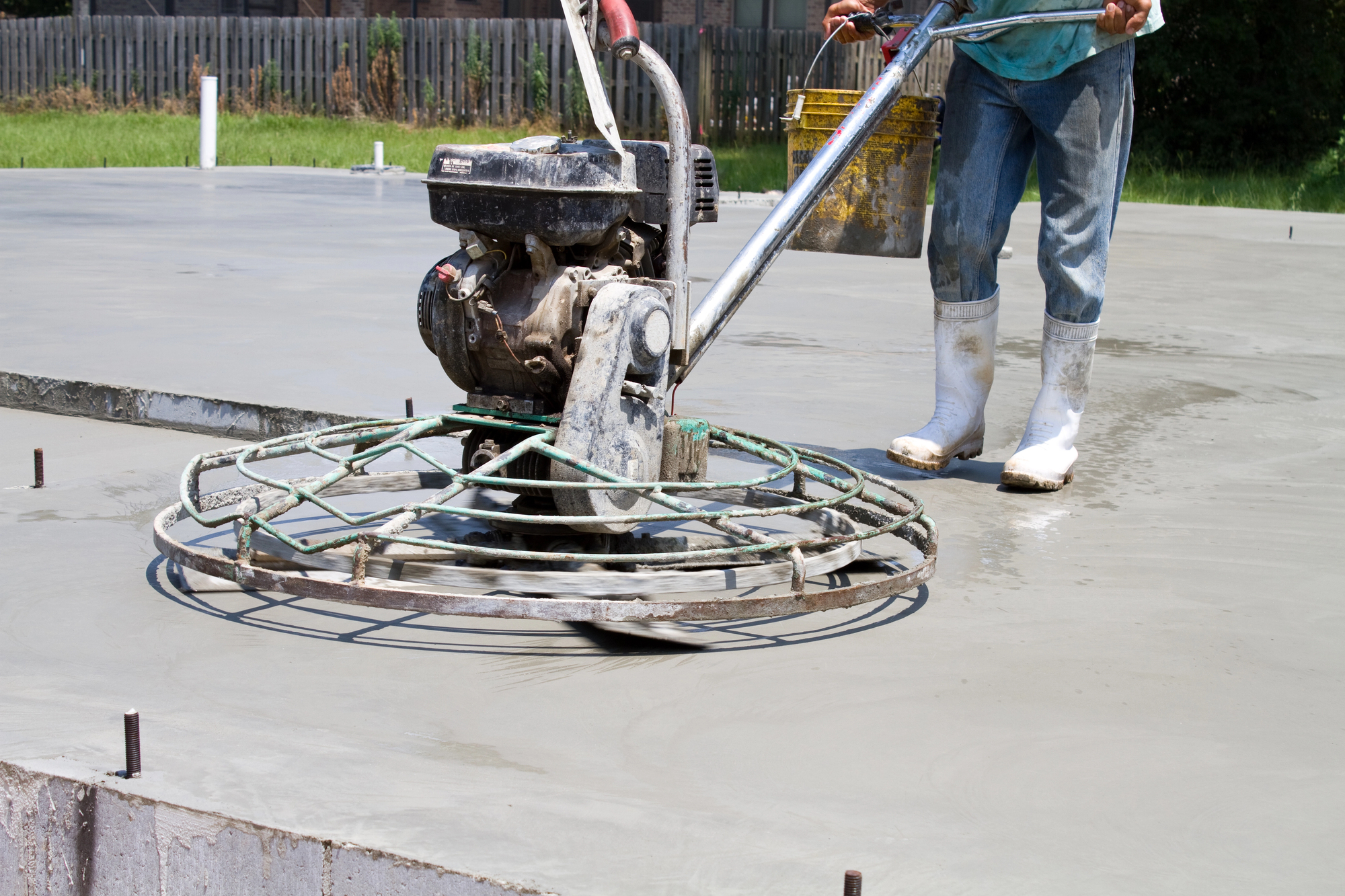 Concrete finishing using power trowel for smooth slab surface