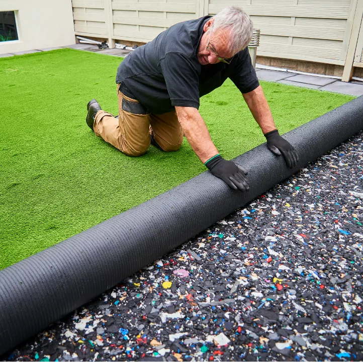 Worker installing artificial turf