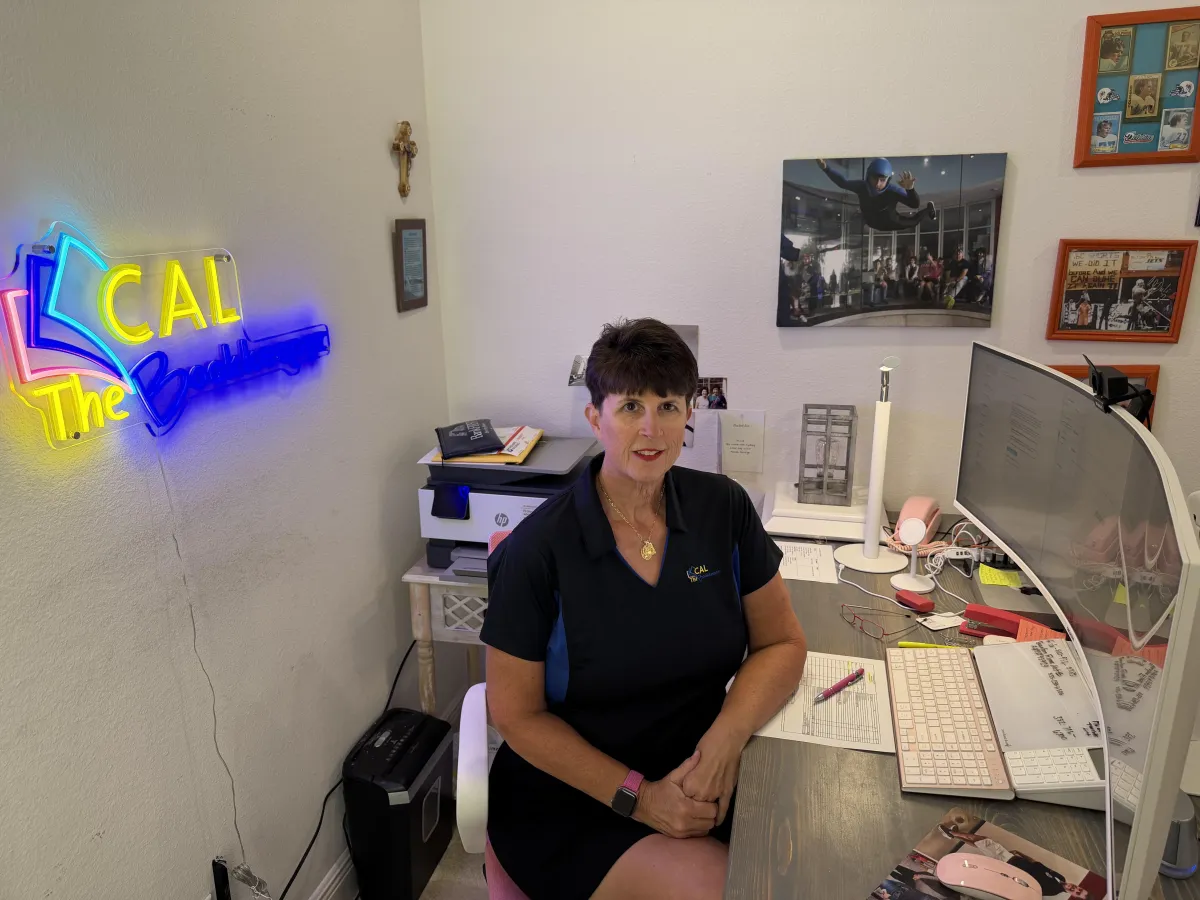 Small business owner in Clermont, Florida, working on financial documents at a cozy desk