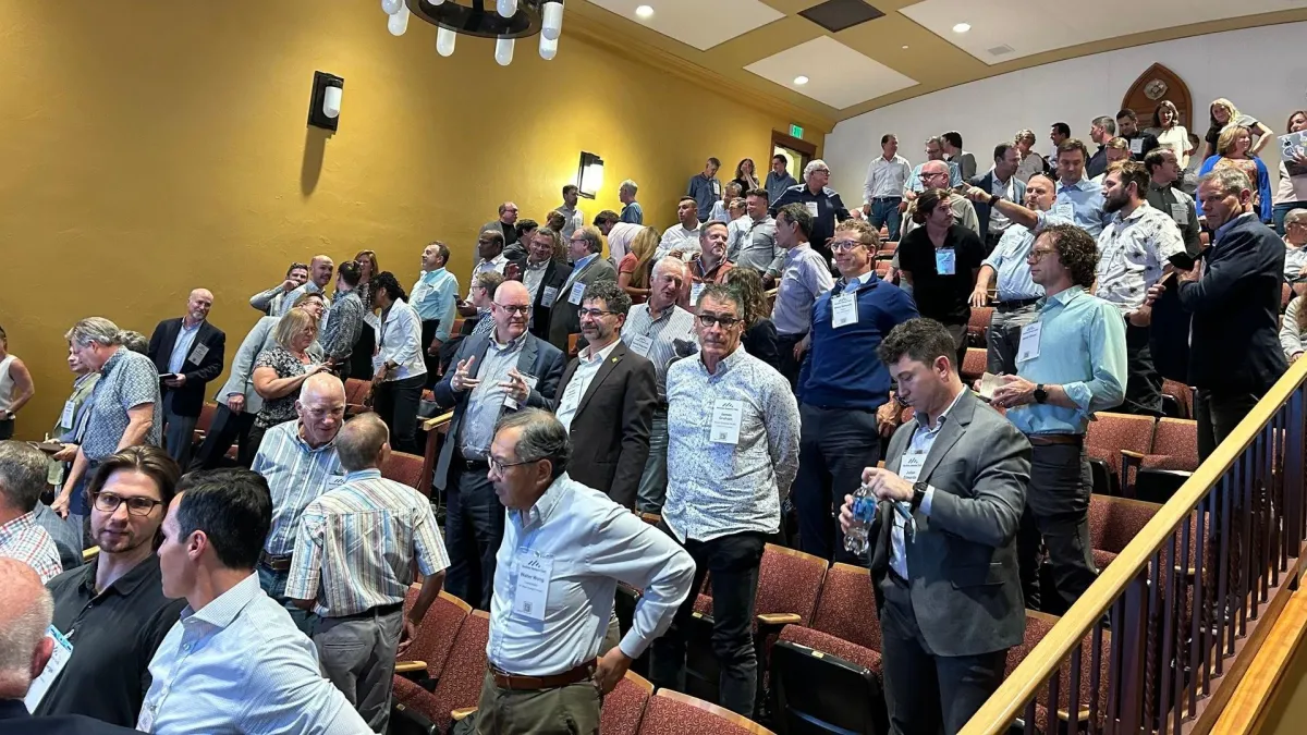 woman in black sweater holding white and black vr goggles