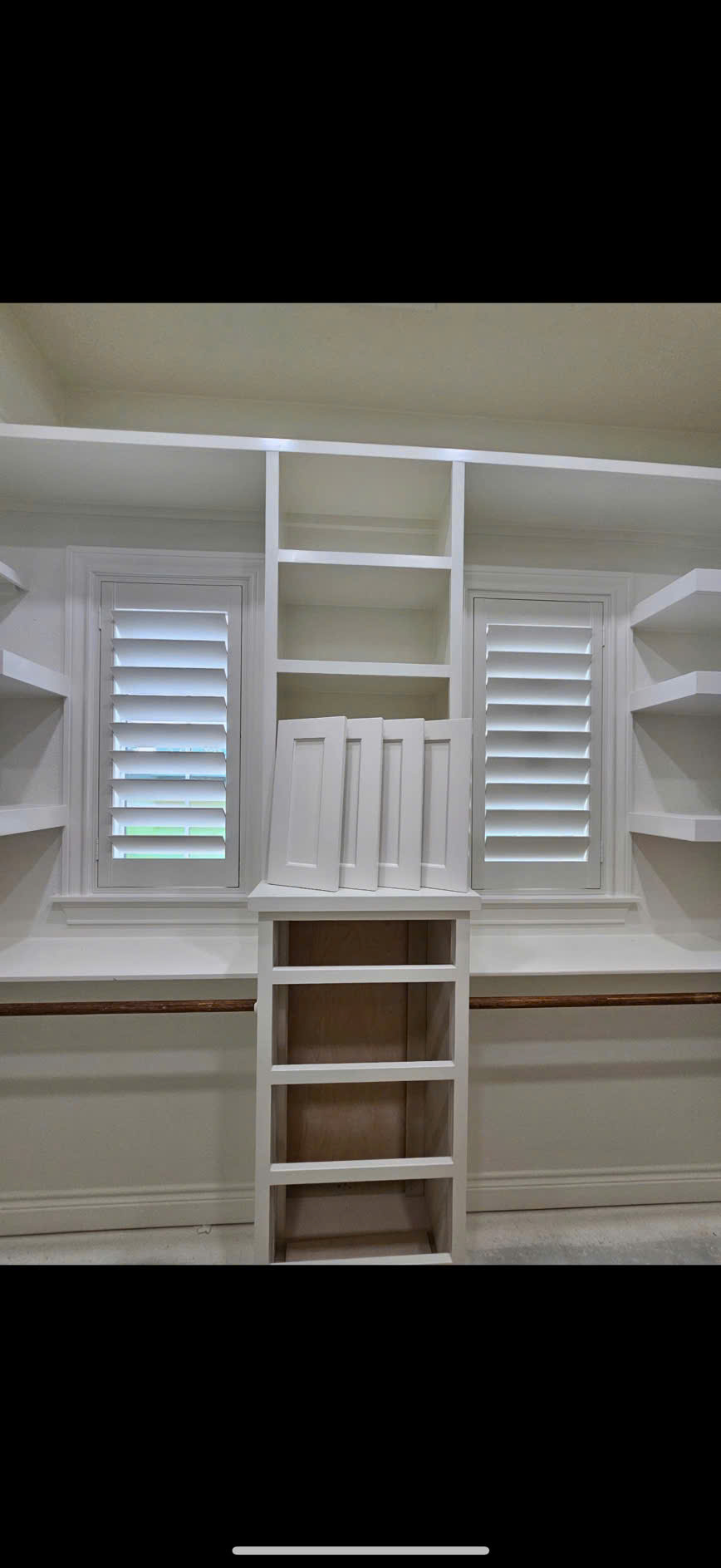 White plantation shutters professionally fitted to a bay window