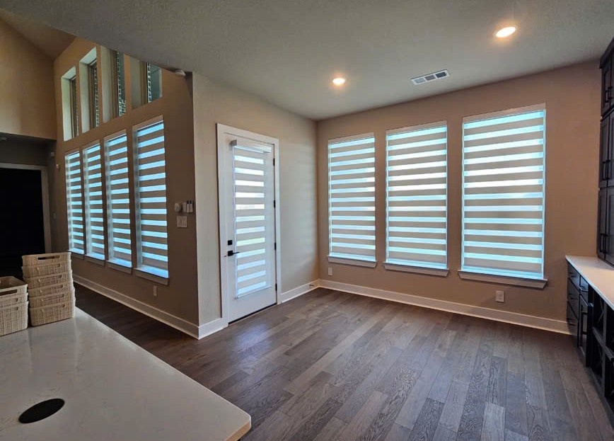 Modern zebra shades installed on windows and a glass entry door