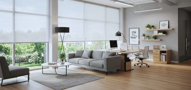 Light-filtering roller shades installed in a bright open-plan living room