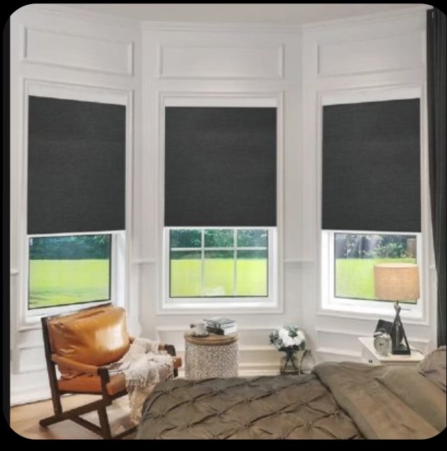 Dark solar shades installed above multiple kitchen windows