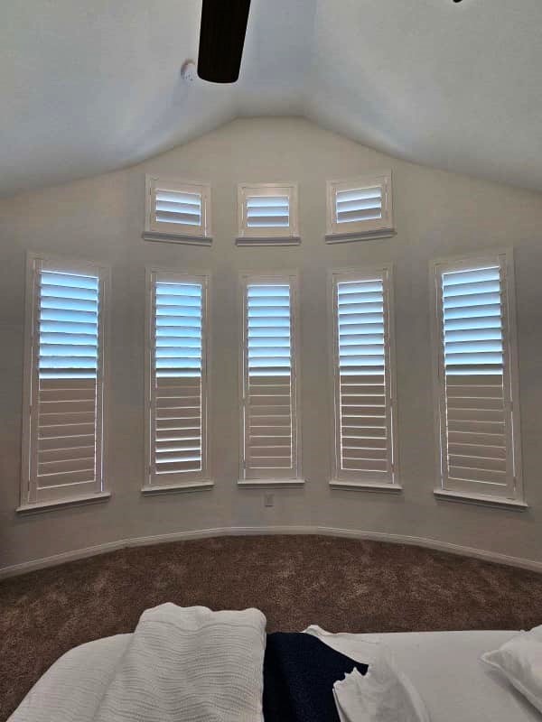 Full height plantation shutters fitted to multiple angled windows