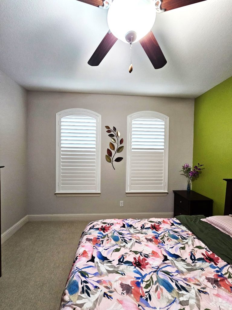 White plantation shutters installed on two bedroom windows