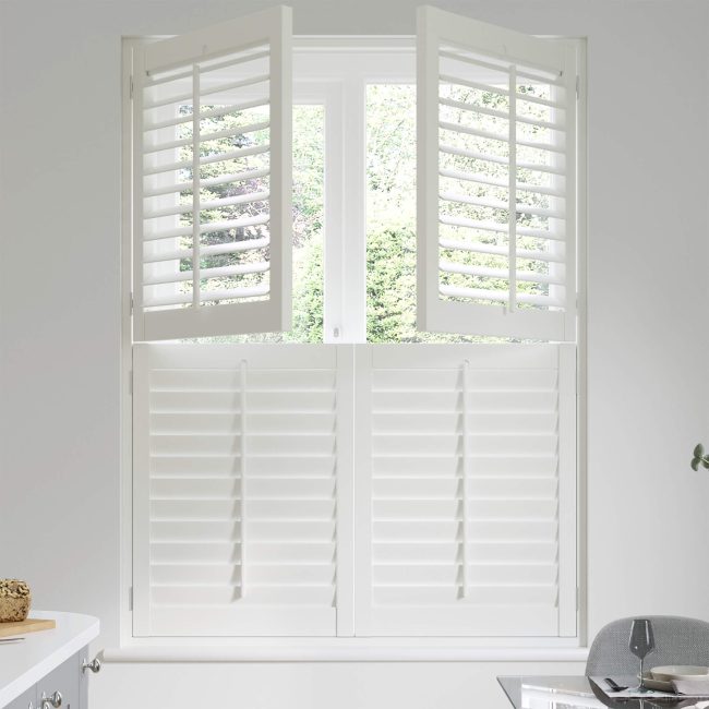 White tier-on-tier shutters providing privacy in a bright bathroom