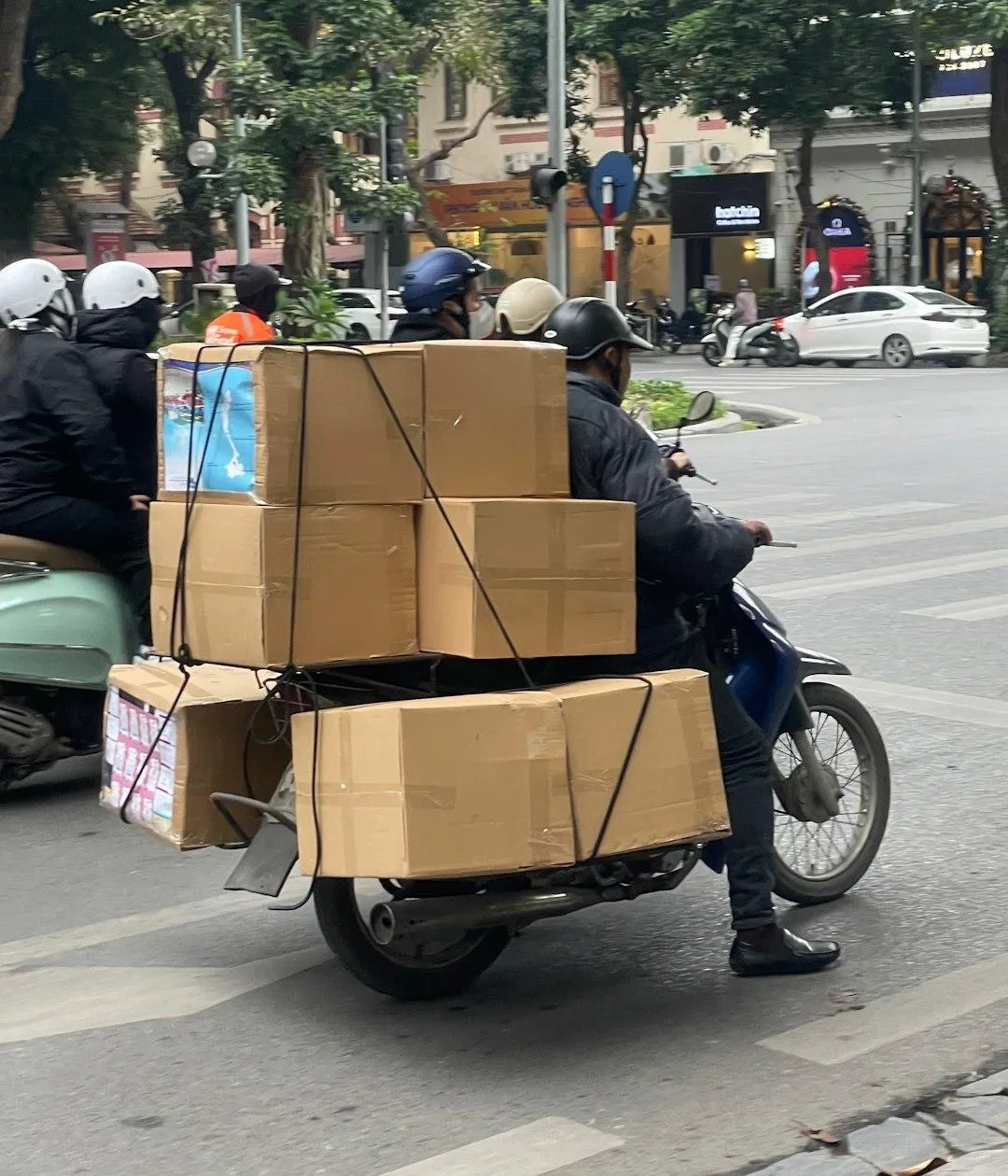 a blue and white bus driving down a street