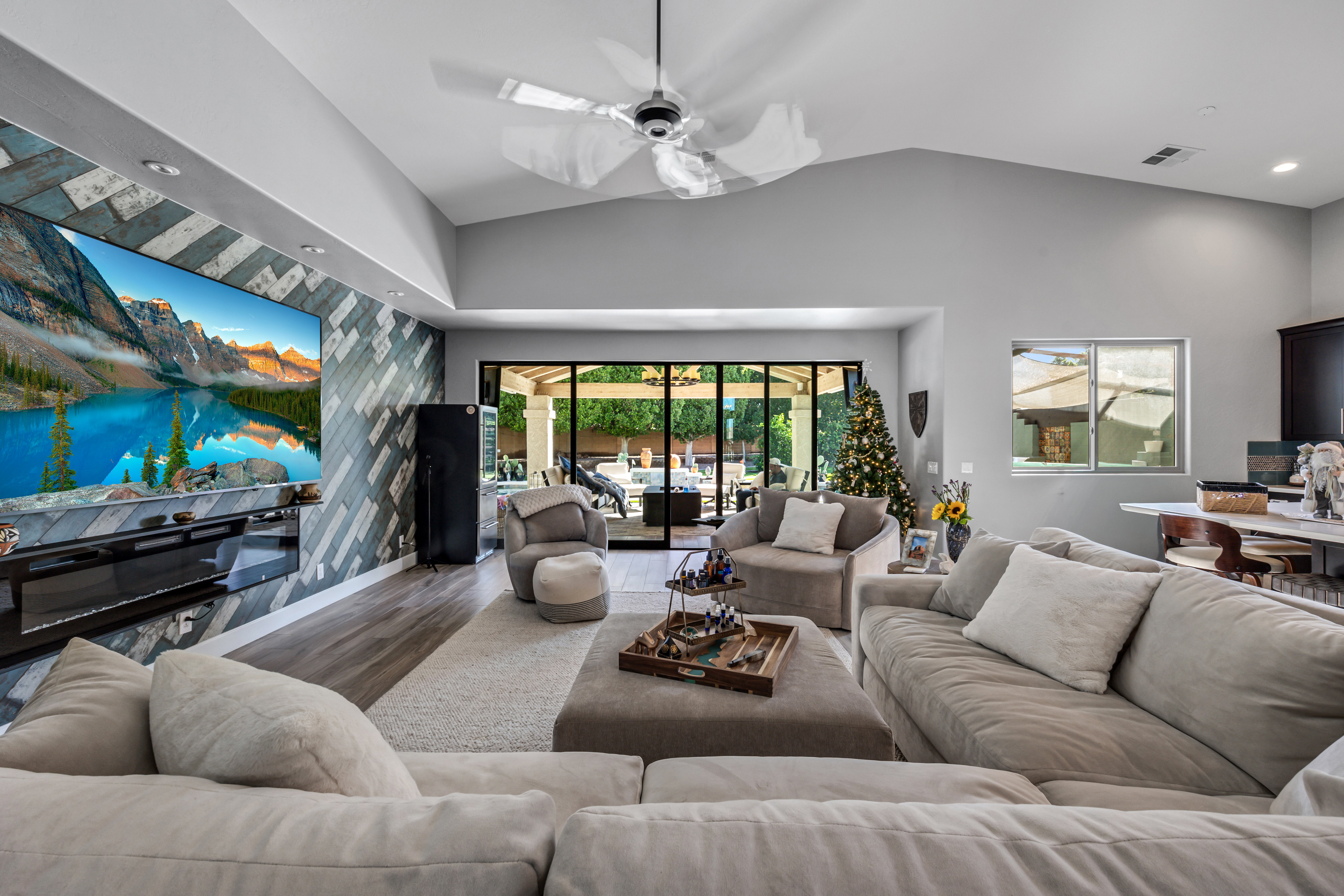 A sunlit bedroom with two twin beds, soft pastel bedding, large windows overlooking a garden, and gentle decorative touches. The room feels peaceful and inviting, designed to foster both rest and connection, with a calming color palette and natural light.