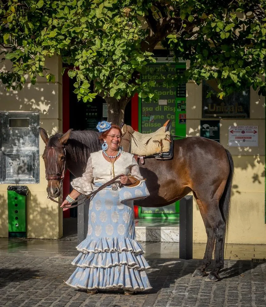 Laughing lady in spanish costume with horse