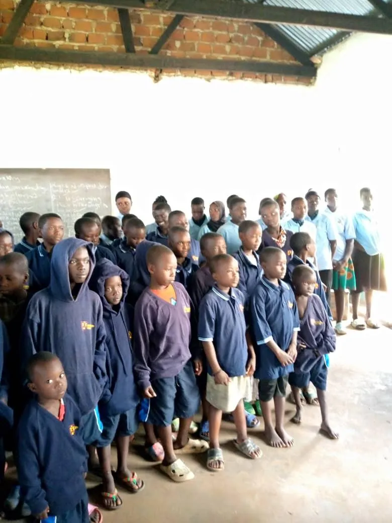 a man and woman wearing graduation gowns and holding a trophy
