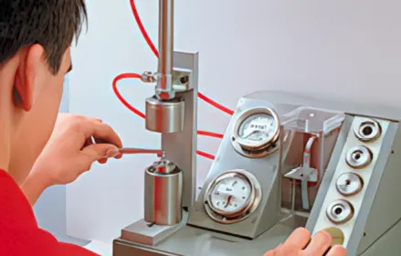 Technician using a specialized bubble-test fixture for performance testing of precision seals in the semiconductor industry.