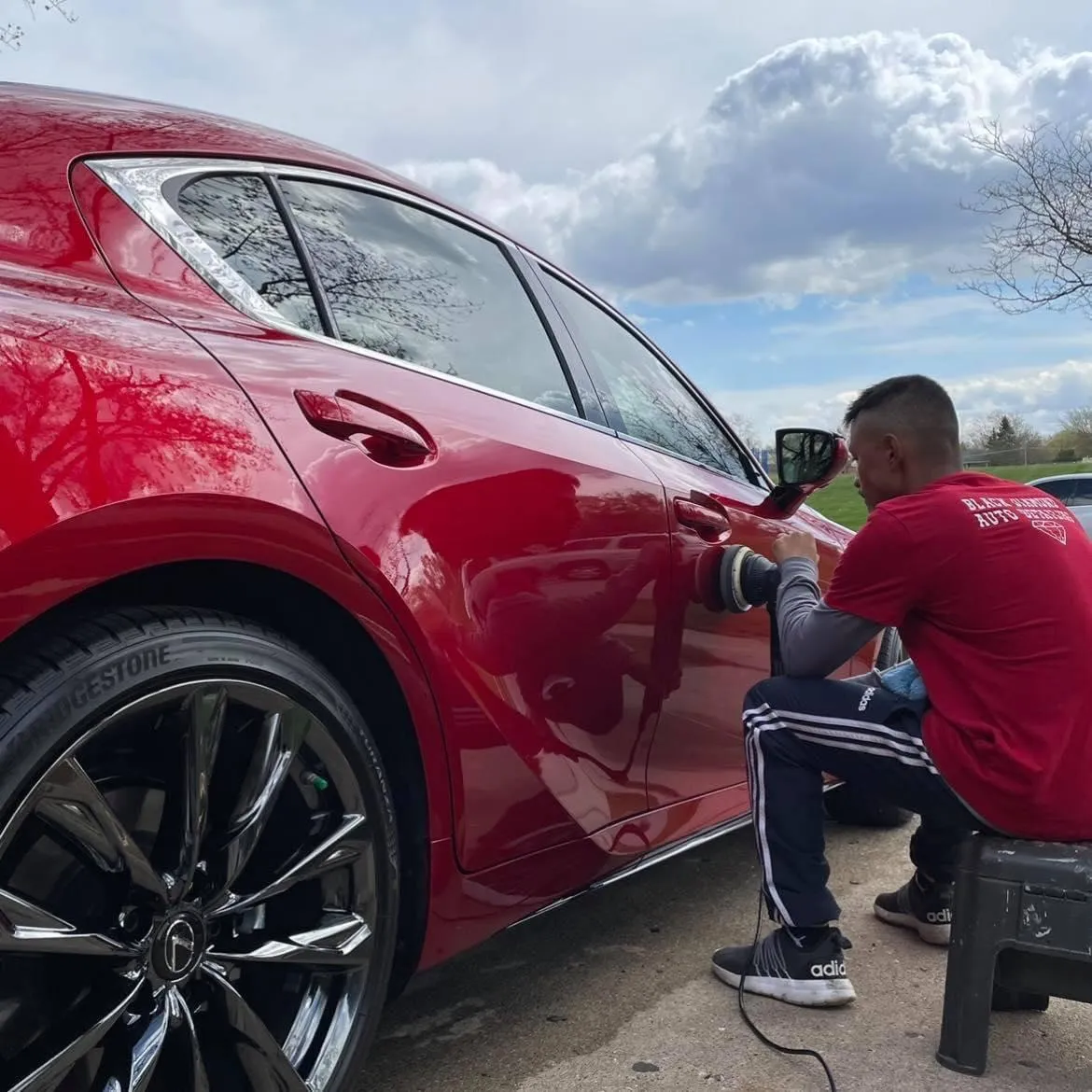 Picture of Jose Gomez detailing a red car