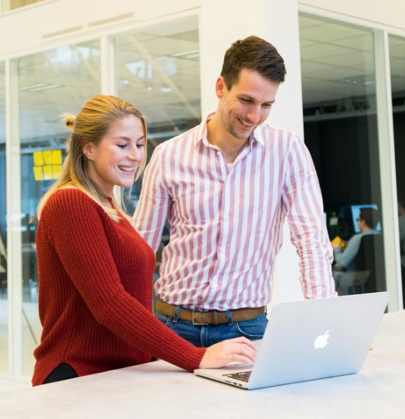 Man and woman working on laptop