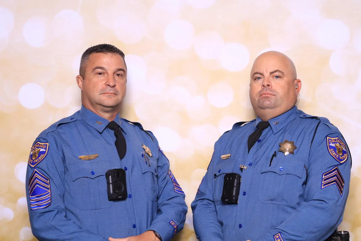 Two Pueblo police officers posing in Martini Moment Photo Booth at community event at the Pueblo Convention Center