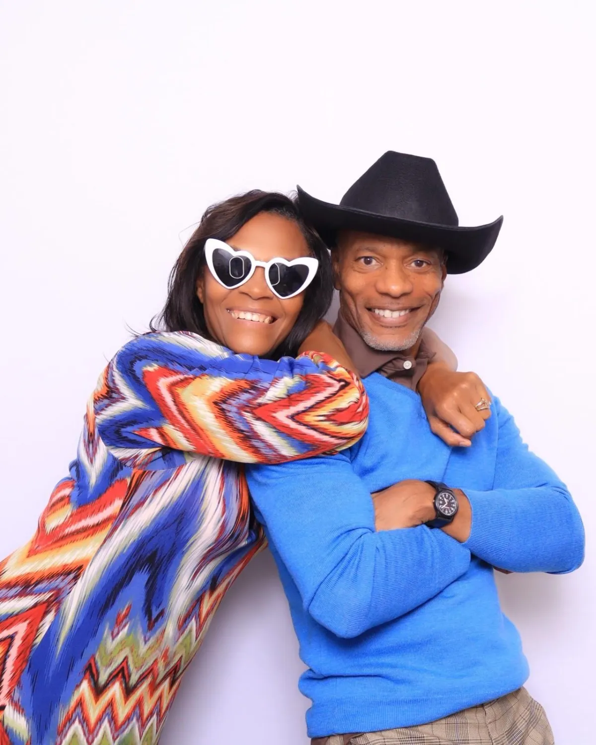 Married Couple having fun with props in a luxury photobooth in Colorado Springs at Premier Event Center