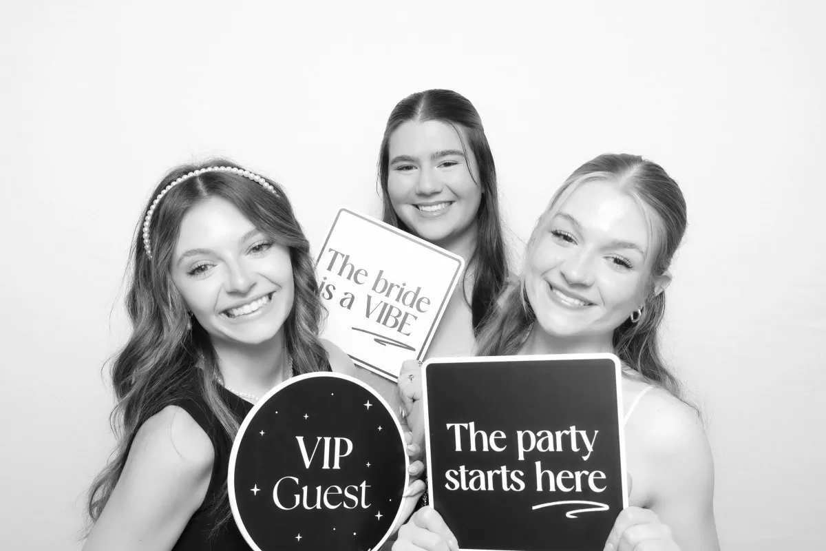 Wedding guests posing with fun props in a luxury photo booth at Spruce Mountain wedding in Larkspur Colorado