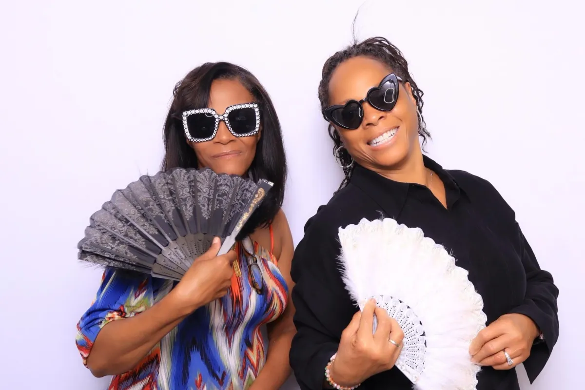 Guests posing with fun props in an elegant photo booth at Premier Event Center in Colorado Springs