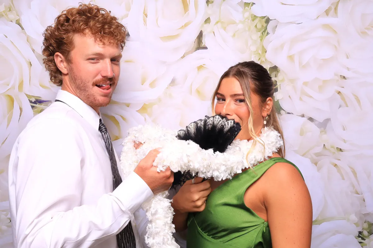 wedding guest posing in luxury photo booth at luxury wedding in colorado springs