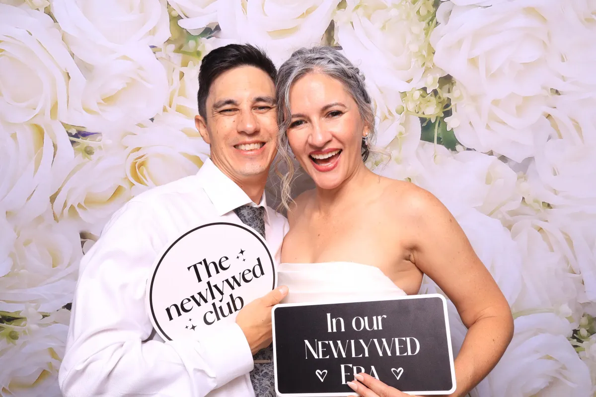 Married Couple having fun with props in a luxury photobooth in Colorado Springs at a phantom canyon brewery wedding