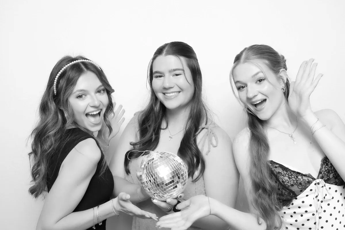 Friends having fun in a luxury photo booth with luxury props in Larkspur Colorado