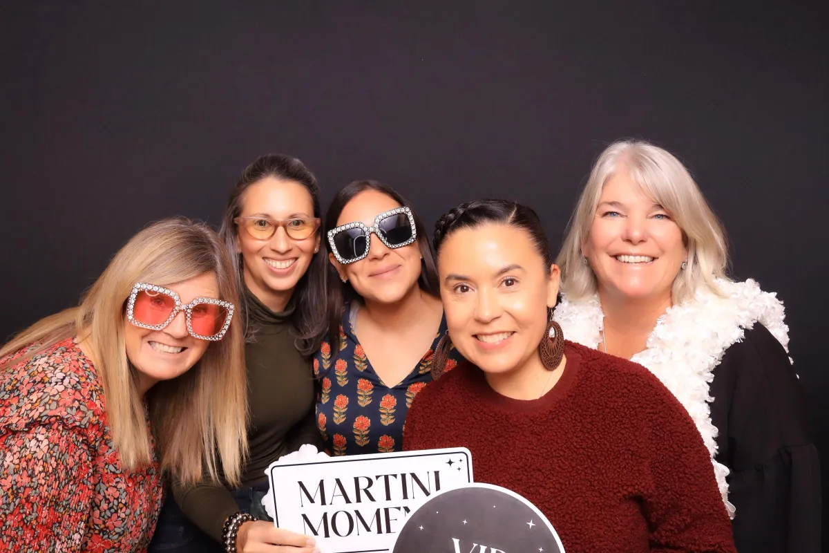 colorado broker and realtors posing with luxury props in a photo booth in canon city