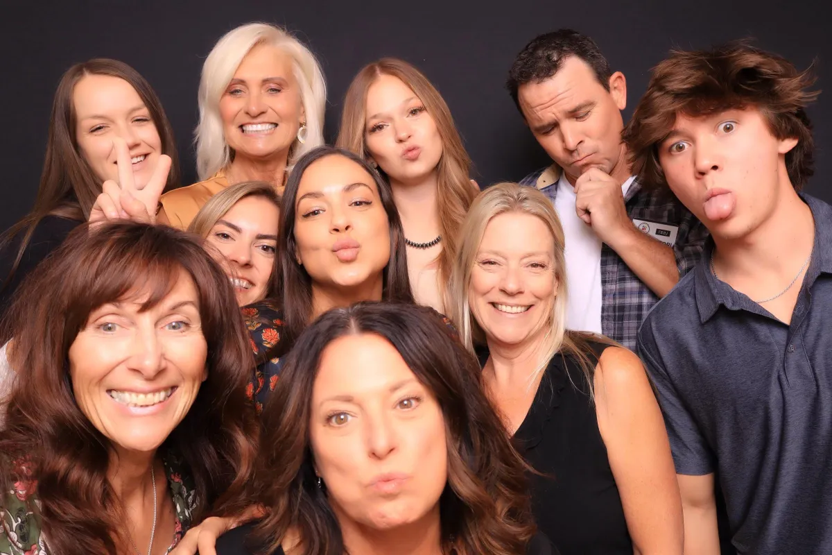 Colorado real estate agents post silly in a luxury photo booth in colorado springs