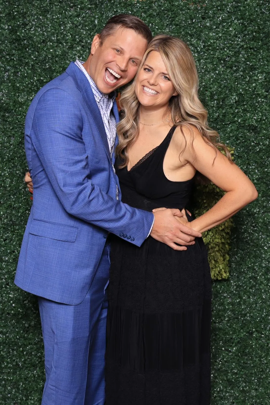 Guests posing with fun props in an elegant photo booth in Colorado Springs