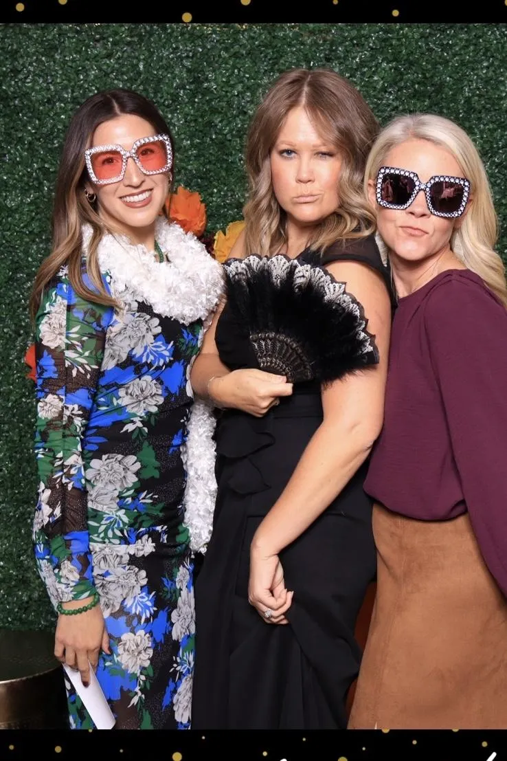 guests posing with fun props in photo booth in pueblo colorado