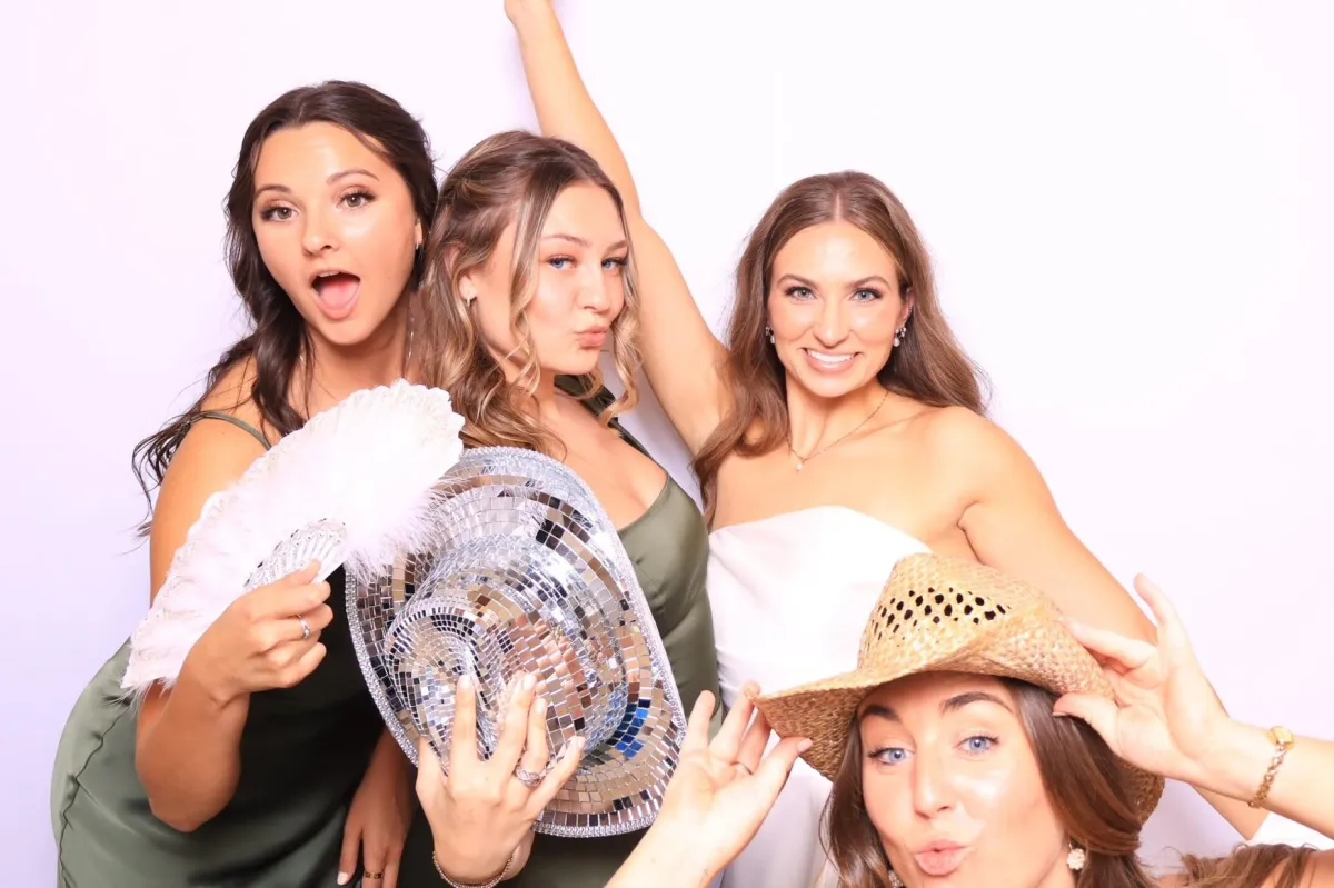 bridesmaids taking photo booth pictures in an upscale wedding in Pueblo