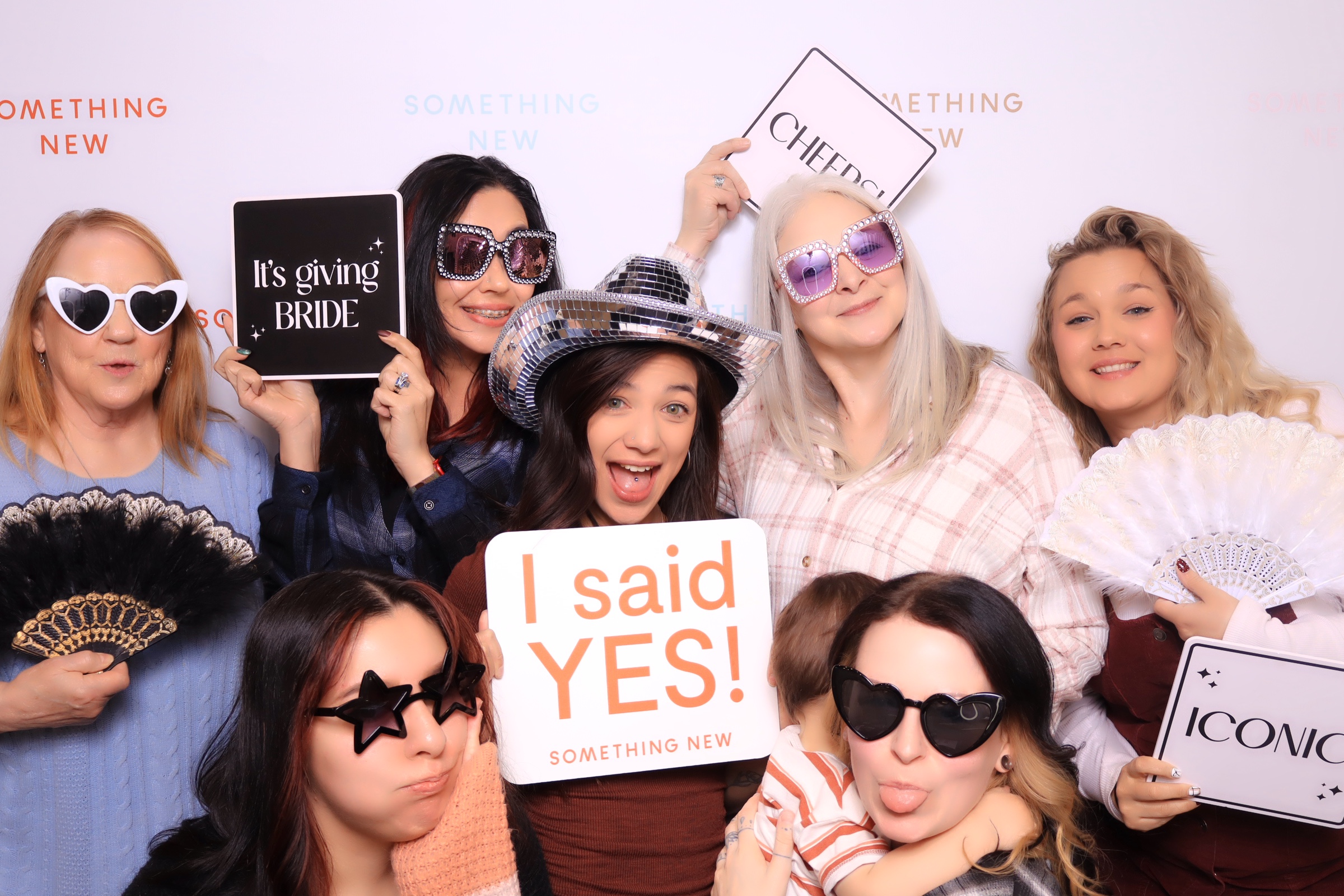 Married Couple having fun with props in a luxury photobooth in Colorado Springs at a phantom canyon brewery wedding