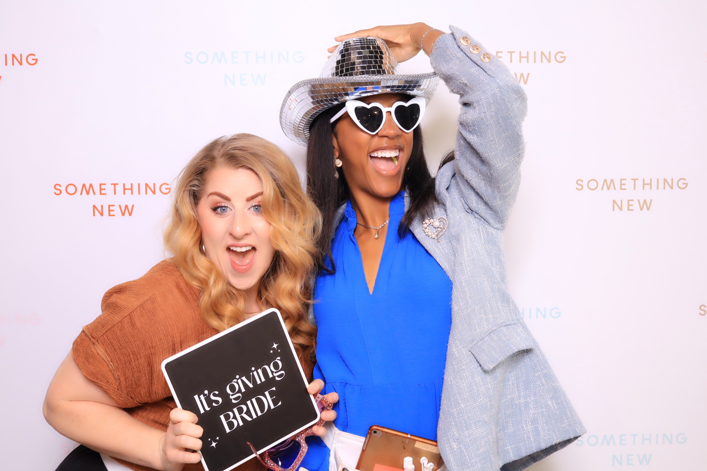 Something New Boutique stylists posing in Martini Moment Photo Booths in colorado springs