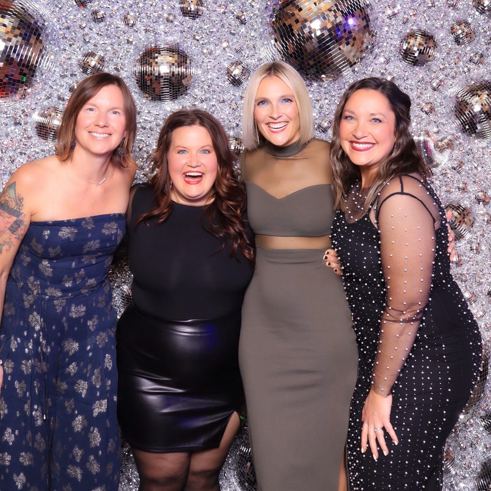 Employees posing together at a corporate holiday party with a glam photo booth experience